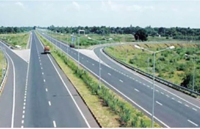 Empty highway with green surroundings.